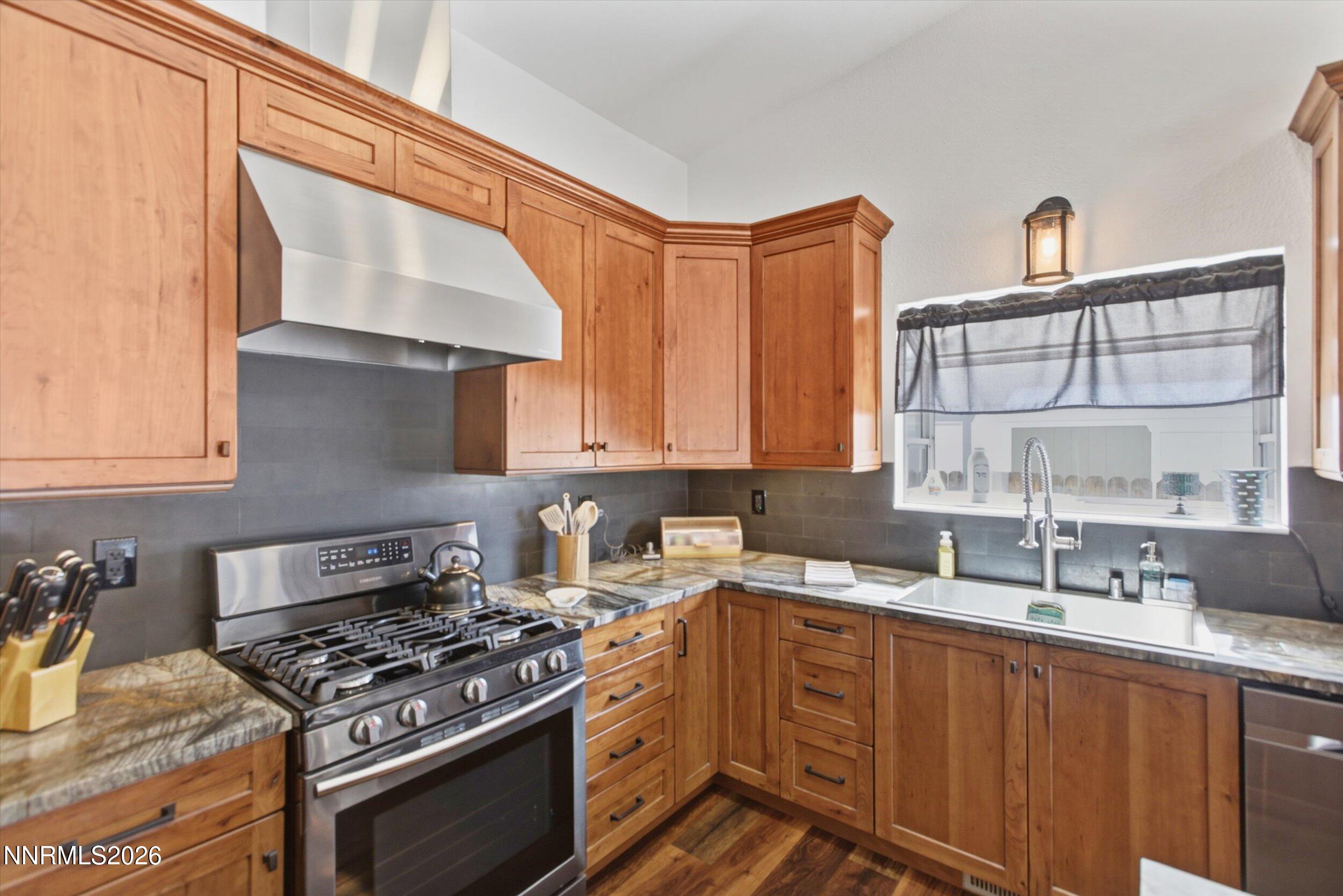 435 Kathy Terrace Sparks, NV 89436 - Photo 27 of 49 a kitchen with stainless steel appliances a stove a sink and a microwave