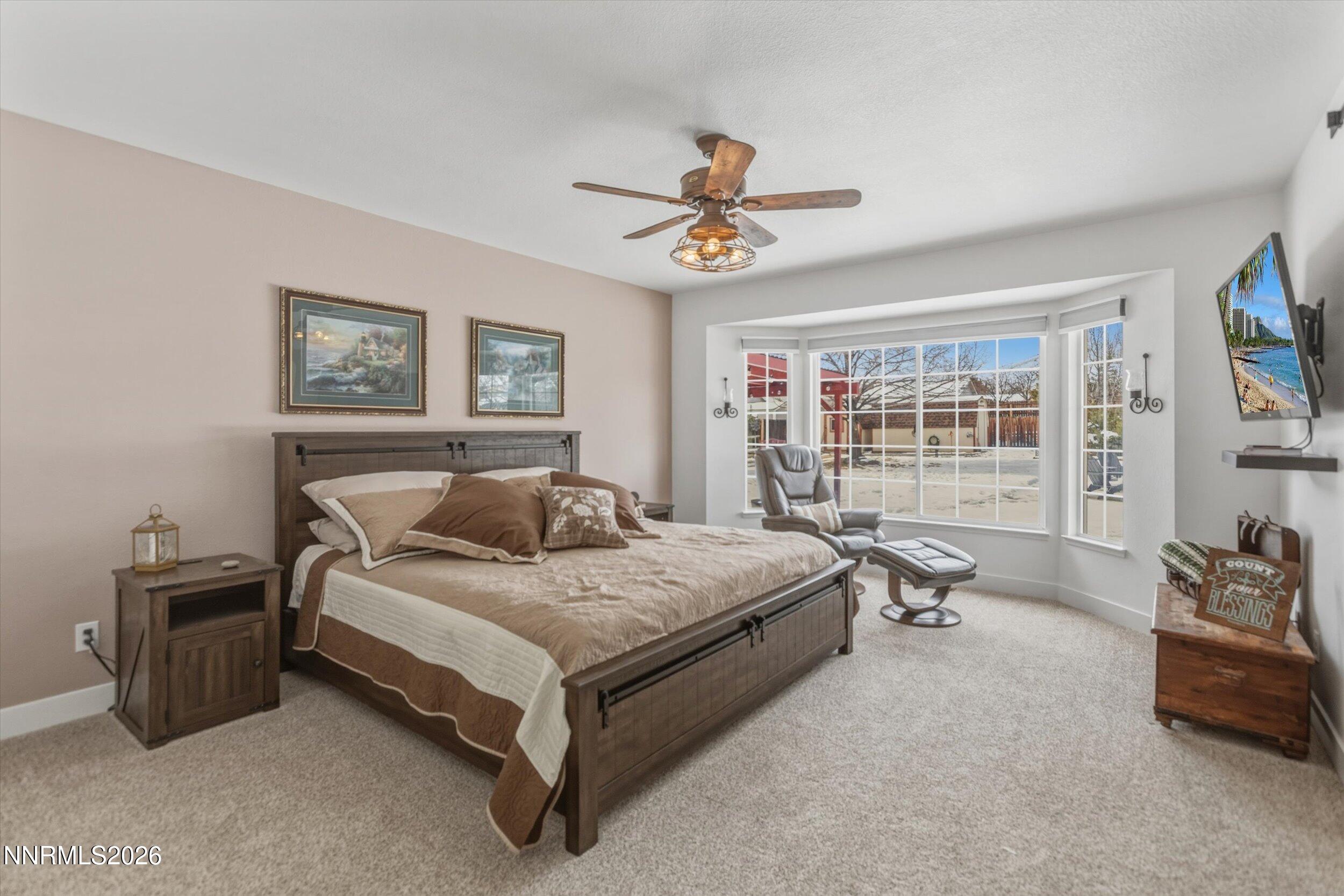 435 Kathy Terrace Sparks, NV 89436 - Photo 3 of 49 a bedroom with a bed and a chandelier