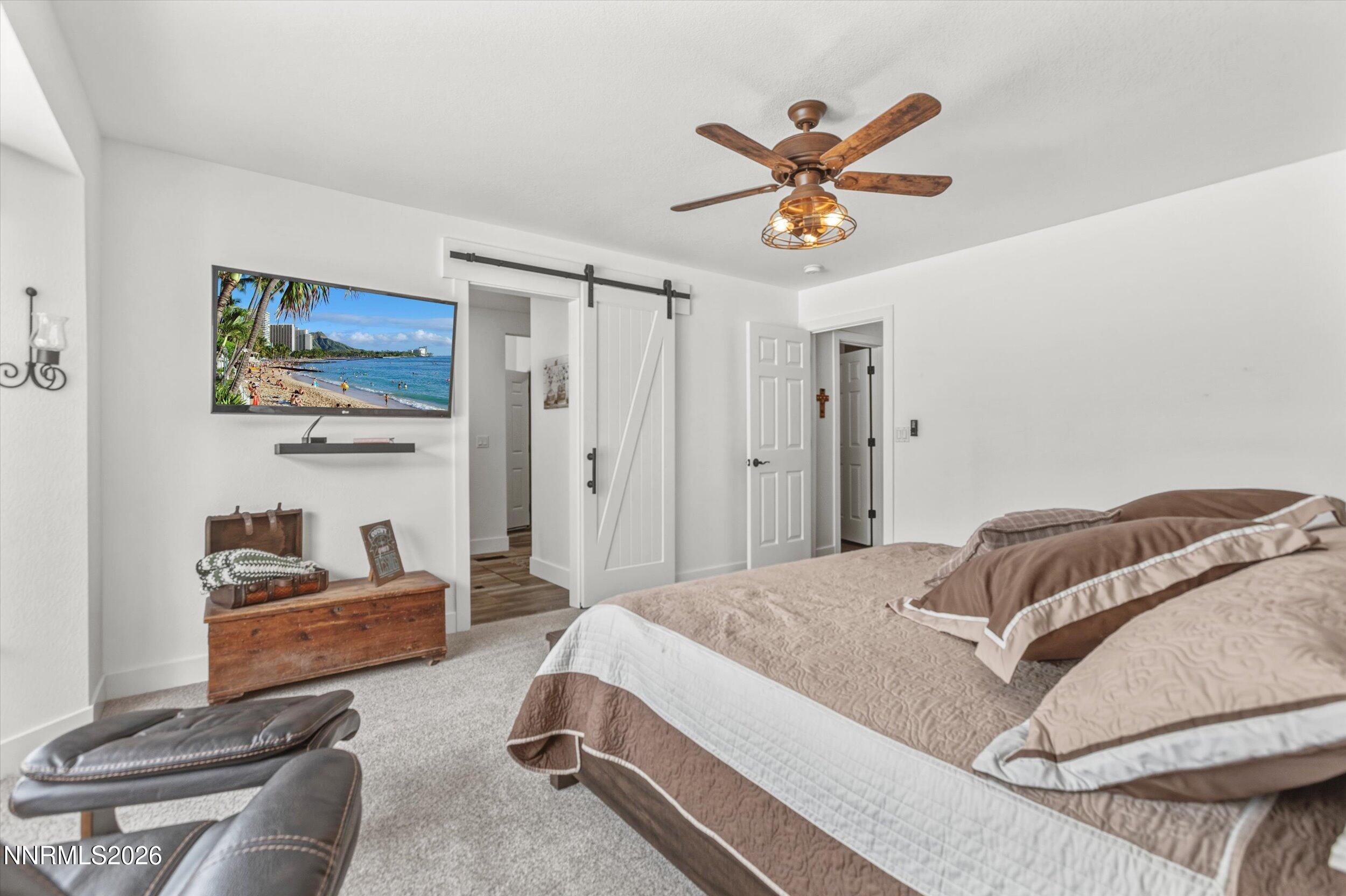 435 Kathy Terrace Sparks, NV 89436 - Photo 4 of 49 a bedroom with a bed and a chandelier