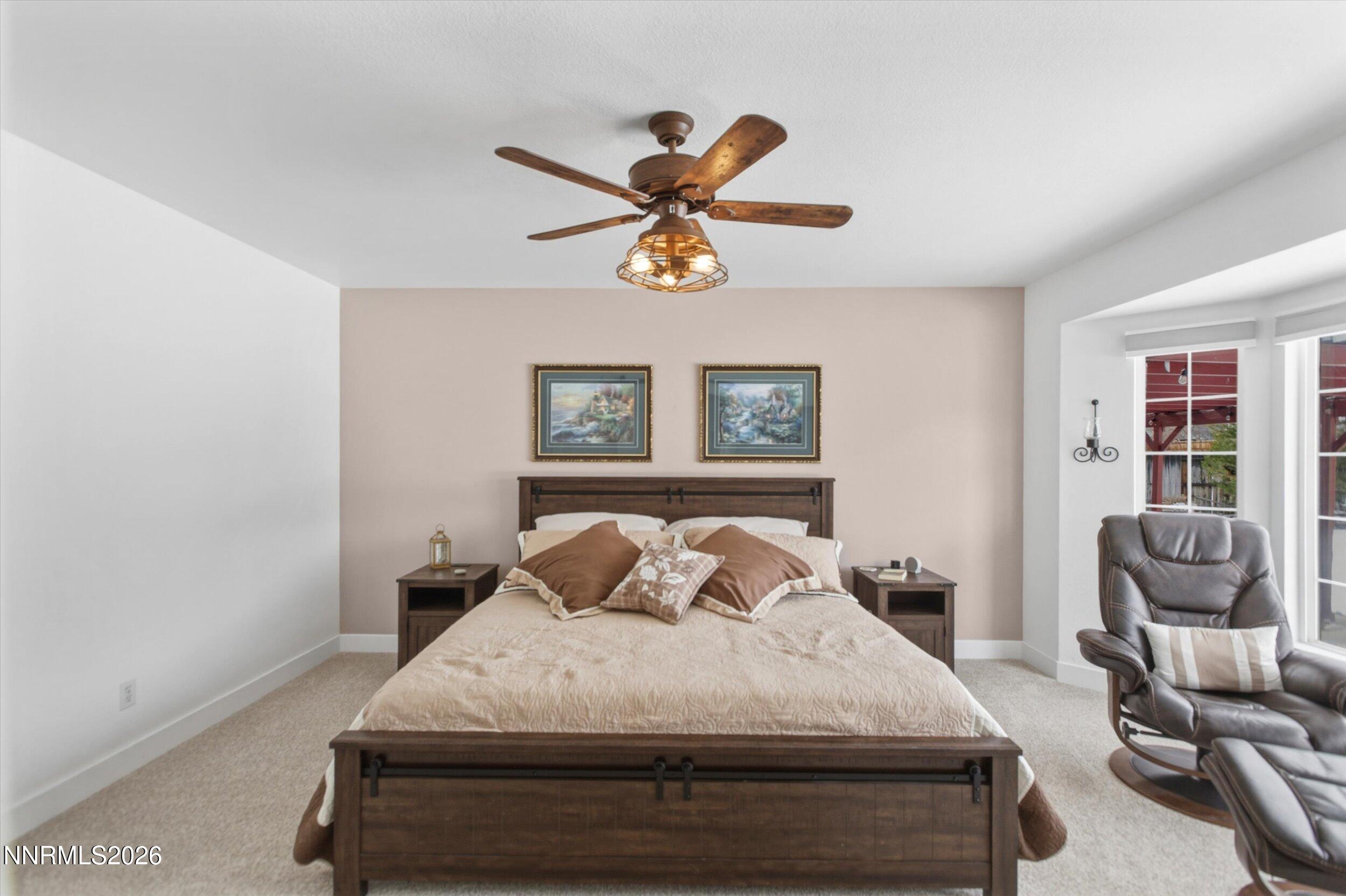 435 Kathy Terrace Sparks, NV 89436 - Photo 5 of 49 a bedroom with a bed and chair