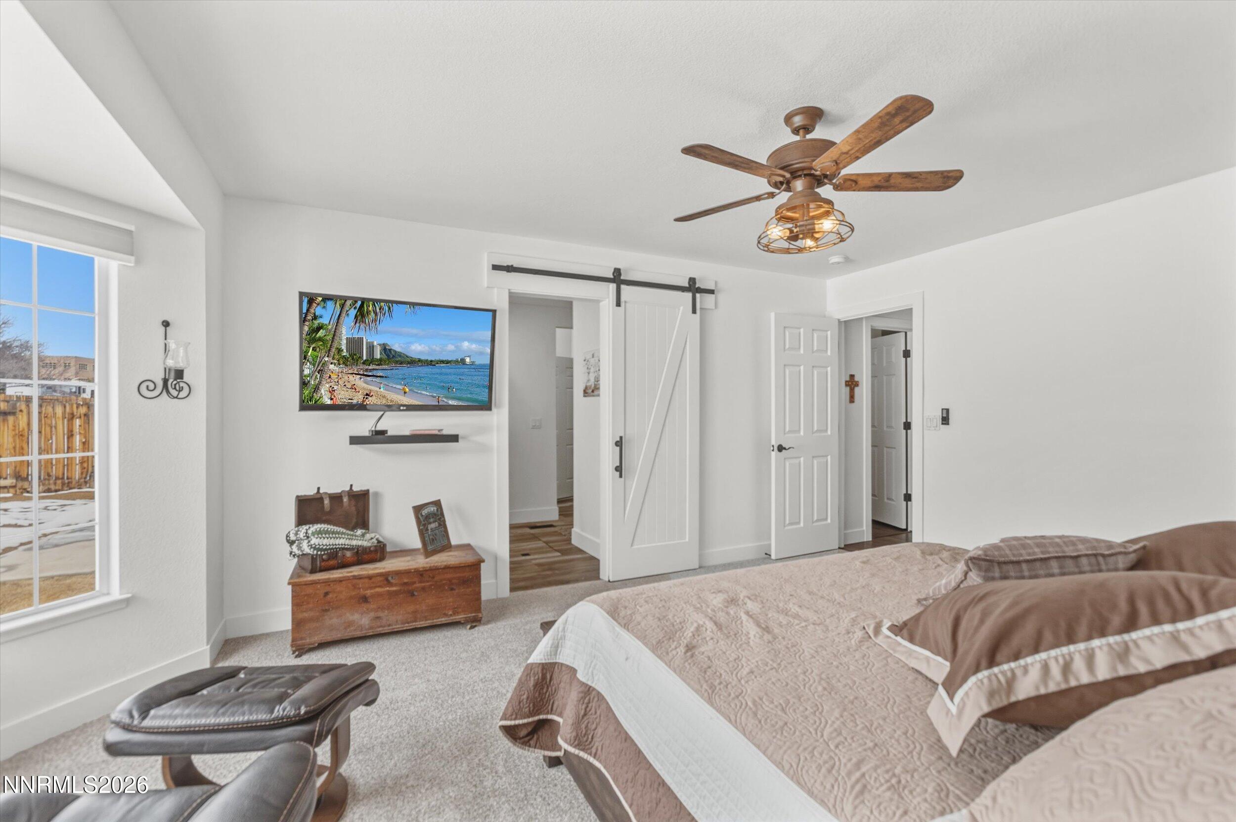 435 Kathy Terrace Sparks, NV 89436 - Photo 6 of 49 a spacious bedroom with a bed and a couch