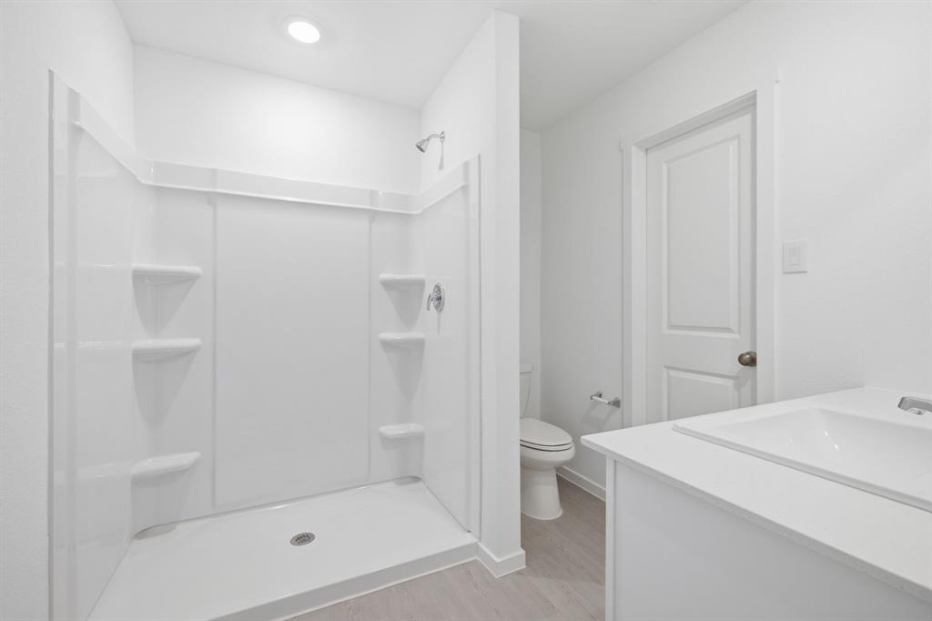 2128 Doc Holliday Road Joshua, TX 76058 - Photo 21 of 28 Shower stall featuring built-in shelving, chrome fixtures, and a white finish