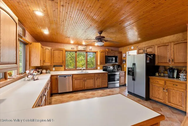 a large kitchen with lots of counter space and stainless steel appliances