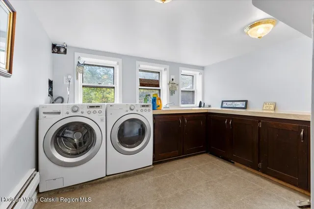 a utility room with sink dryer and washer