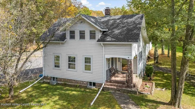 a house with a tree in front of it