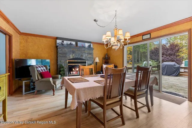 a dining room with furniture garden view and a chandelier