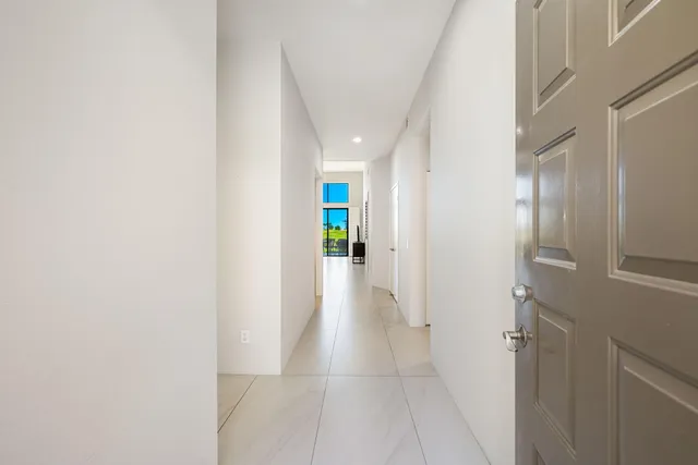 a view of a hallway with wooden shelves
