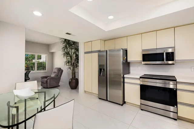 a kitchen with stainless steel appliances a stove a microwave and a refrigerator