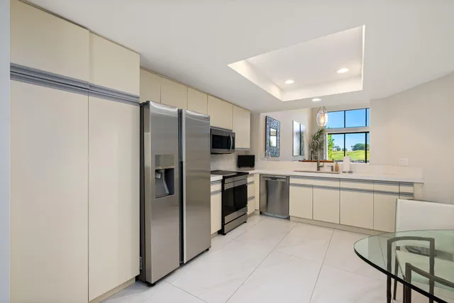 a kitchen with a refrigerator and a sink