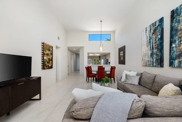a living room with furniture and a floor to ceiling window