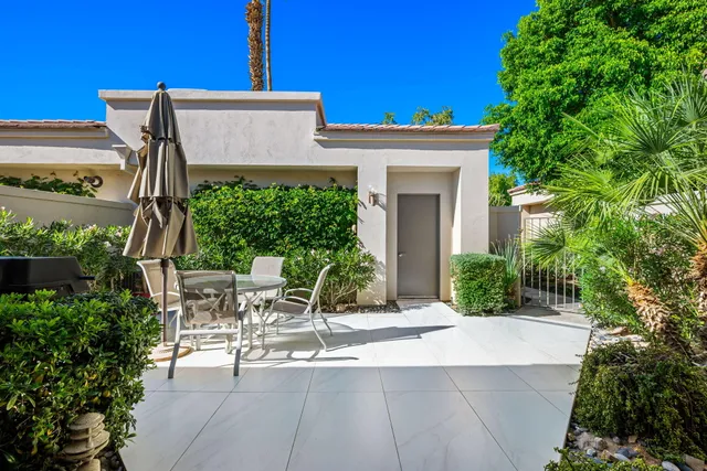 a view of a patio with table and chairs and potted plants