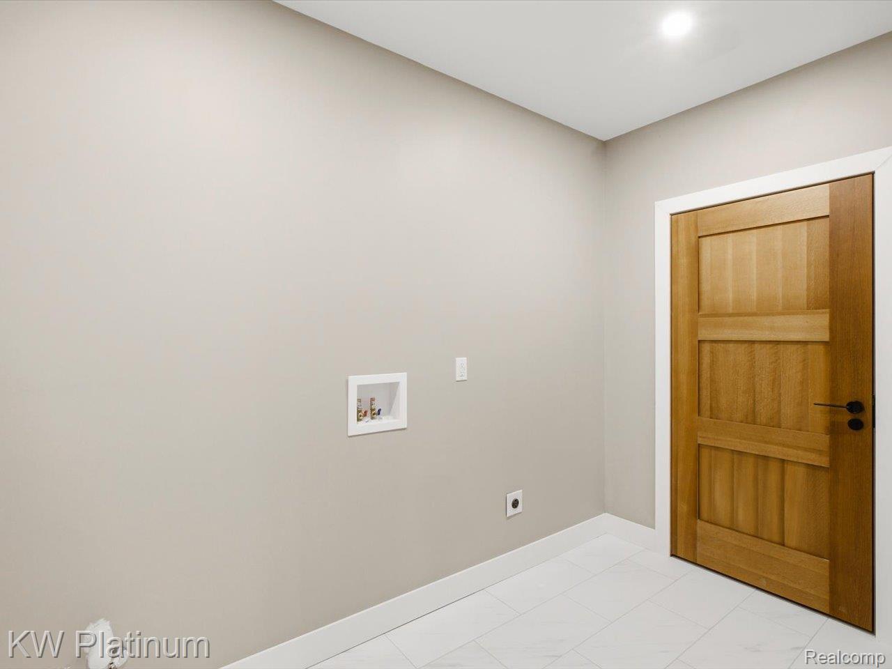 493 Wood Road Snover, MI 48472 - Photo 44 of 60 Laundry area featuring a wood-panel door, recessed lighting, and white tile flooring