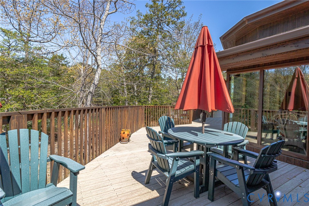 176 Baypointe Court Reedville, VA 22539 - Photo 13 of 60 a view of deck with a table and chairs a barbeque with wooden floor and fence