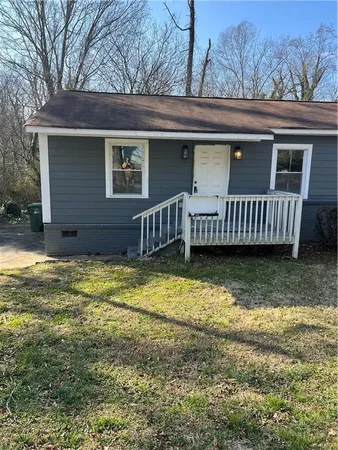 a view of a house with a yard and roof deck