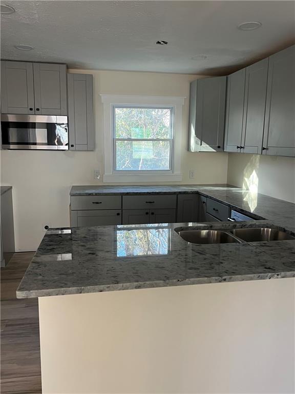 2298 Swallow Circle Southeast Atlanta, GA 30315 - Photo 3 of 10 a kitchen with granite countertop a sink a stove and cabinets