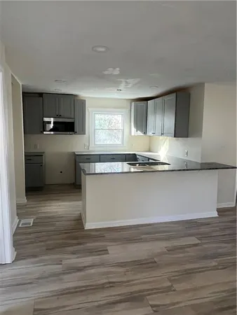 a kitchen with granite countertop a stove and a sink