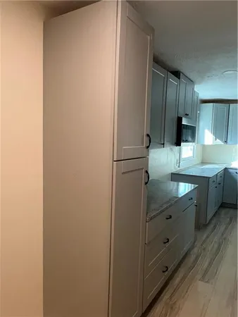 a kitchen with a refrigerator and a sink