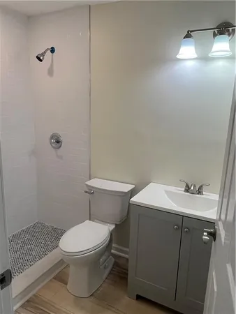 a bathroom with a sink toilet and shower