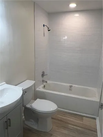 a bathroom with a toilet and a bath tub
