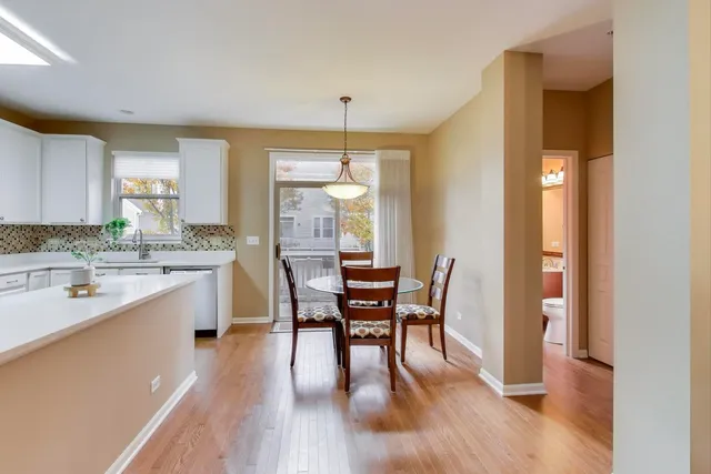a dining room with a wooden table and chairs