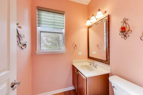 a bathroom with a sink a toilet and mirror
