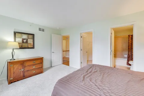 a bedroom with a bed and a dresser in it