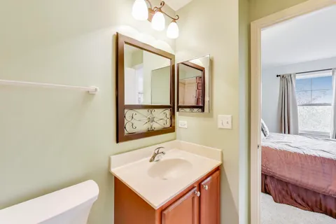 a bathroom with a sink a toilet and mirror