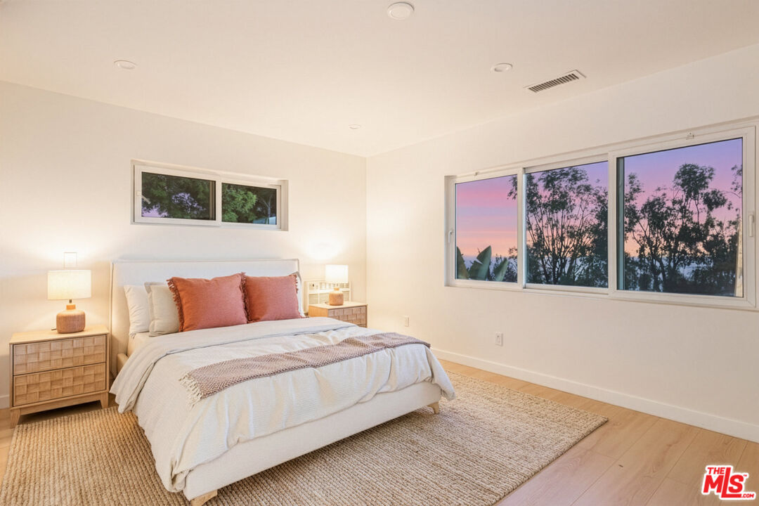 2442 South Coast Highway, Unit 3 Laguna Beach, CA 92651 - Photo 12 of 30 a bedroom with a bed and painting on the wall