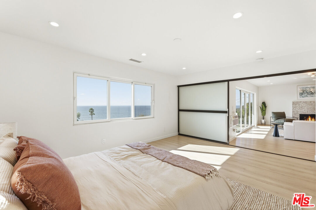 2442 South Coast Highway, Unit 3 Laguna Beach, CA 92651 - Photo 15 of 30 a bedroom with a bed and a window