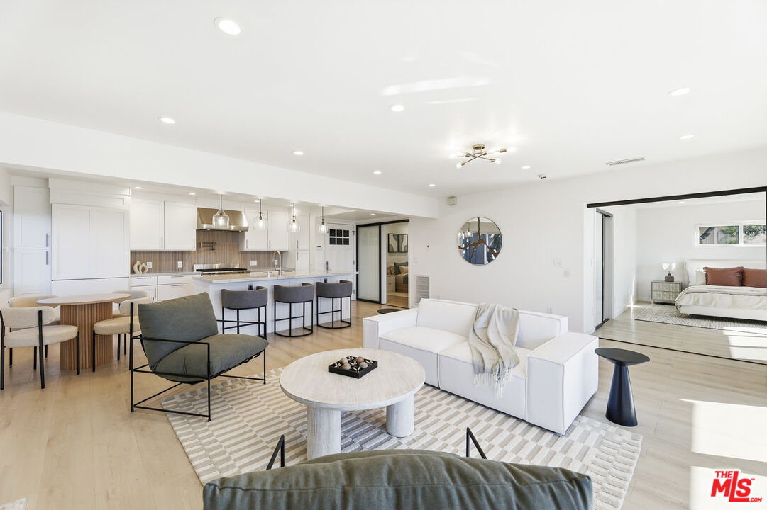 2442 South Coast Highway, Unit 3 Laguna Beach, CA 92651 - Photo 17 of 30 a living room with furniture and wooden floor