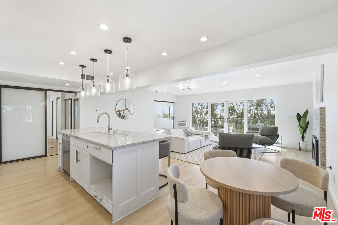 2442 South Coast Highway, Unit 3 Laguna Beach, CA 92651 - Photo 22 of 30 a large kitchen with kitchen island a large counter top space a sink stainless steel appliances and cabinets