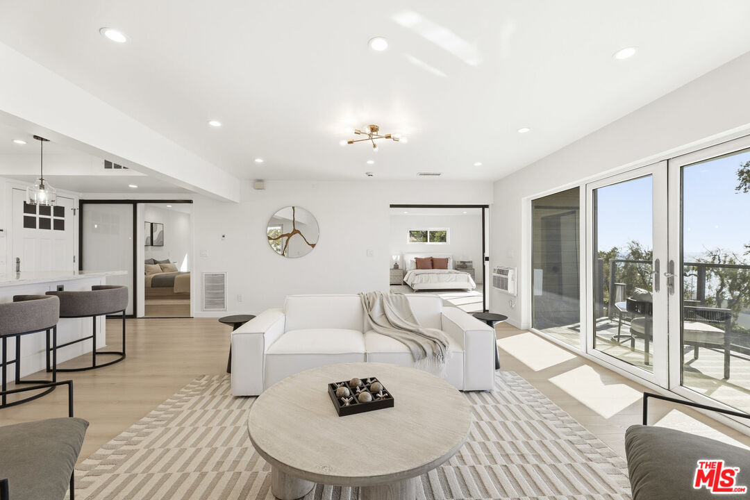 2442 South Coast Highway, Unit 3 Laguna Beach, CA 92651 - Photo 8 of 30 a living room with furniture a large window and wooden floor