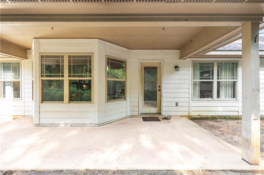 19 Isbell Road Fort Mitchell, AL 36856 - Photo 34 of 37 Covered patio with a concrete surface, white horizontal siding, and multiple windows