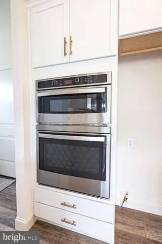 a stove top oven sitting inside of a kitchen