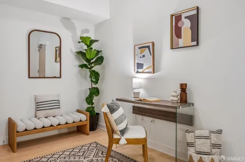 a living room with furniture a table and chairs