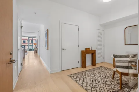 a view of a bedroom with furniture and floor to ceiling window