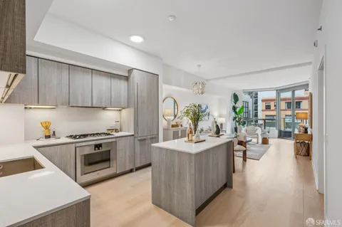 a kitchen with a sink stove and wooden cabinets