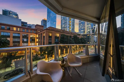 a balcony with furniture and a large window