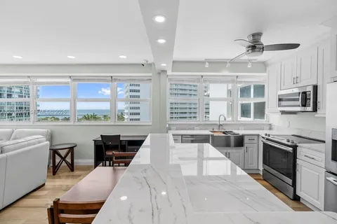 a kitchen with stainless steel appliances granite countertop a stove and a sink