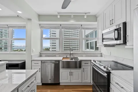 a kitchen with stainless steel appliances a stove a sink and a refrigerator