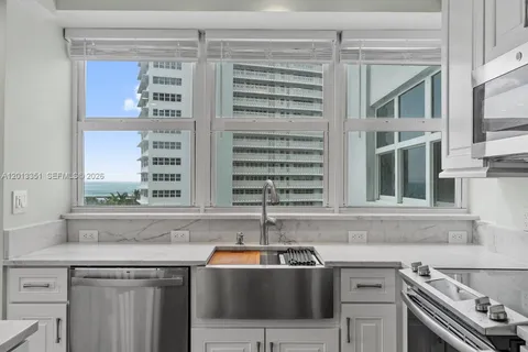 a close view of a sink and a kitchen appliances