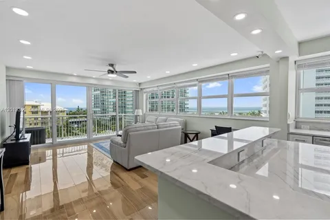 a living room with couches a coffee table and chairs with outer view