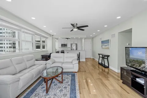 a living room with furniture a flat screen tv and a table