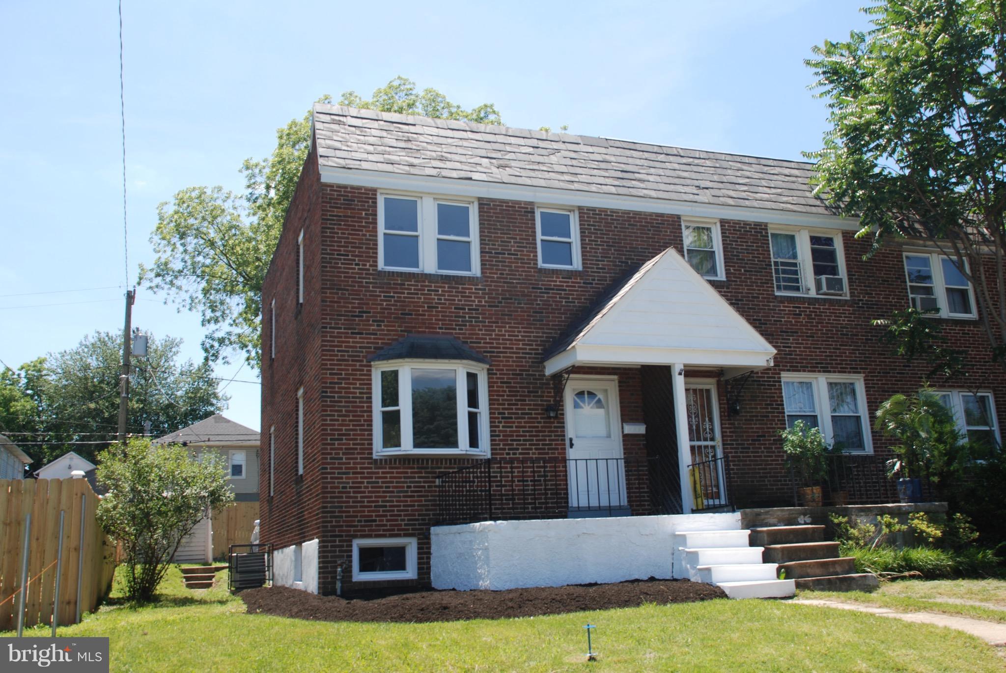 139 West Meadow Road Baltimore, MD 21225 - Photo 1 of 11 a front view of a house with yard and green space