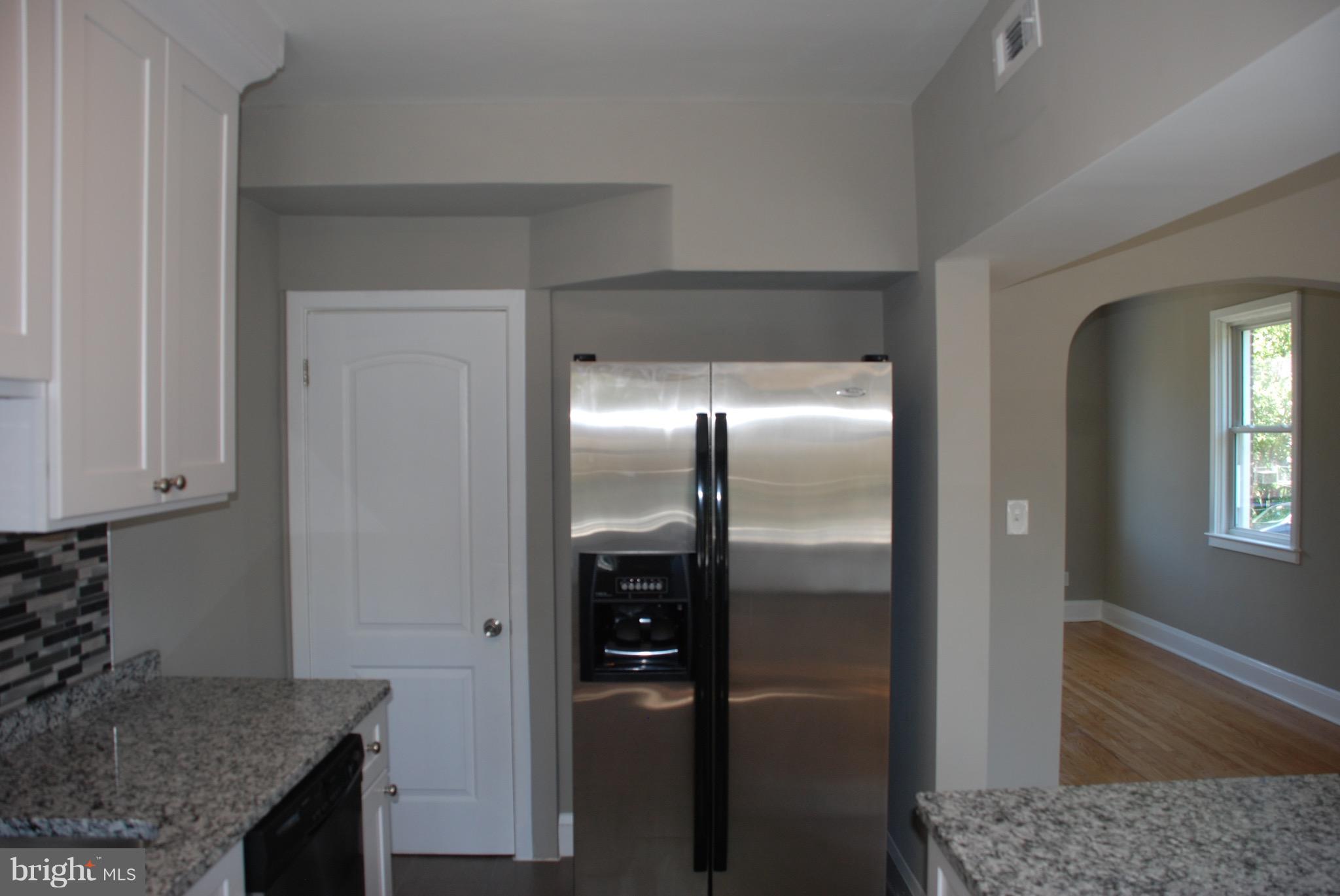 139 West Meadow Road Baltimore, MD 21225 - Photo 3 of 11 a kitchen with stainless steel appliances granite countertop a refrigerator and a sink