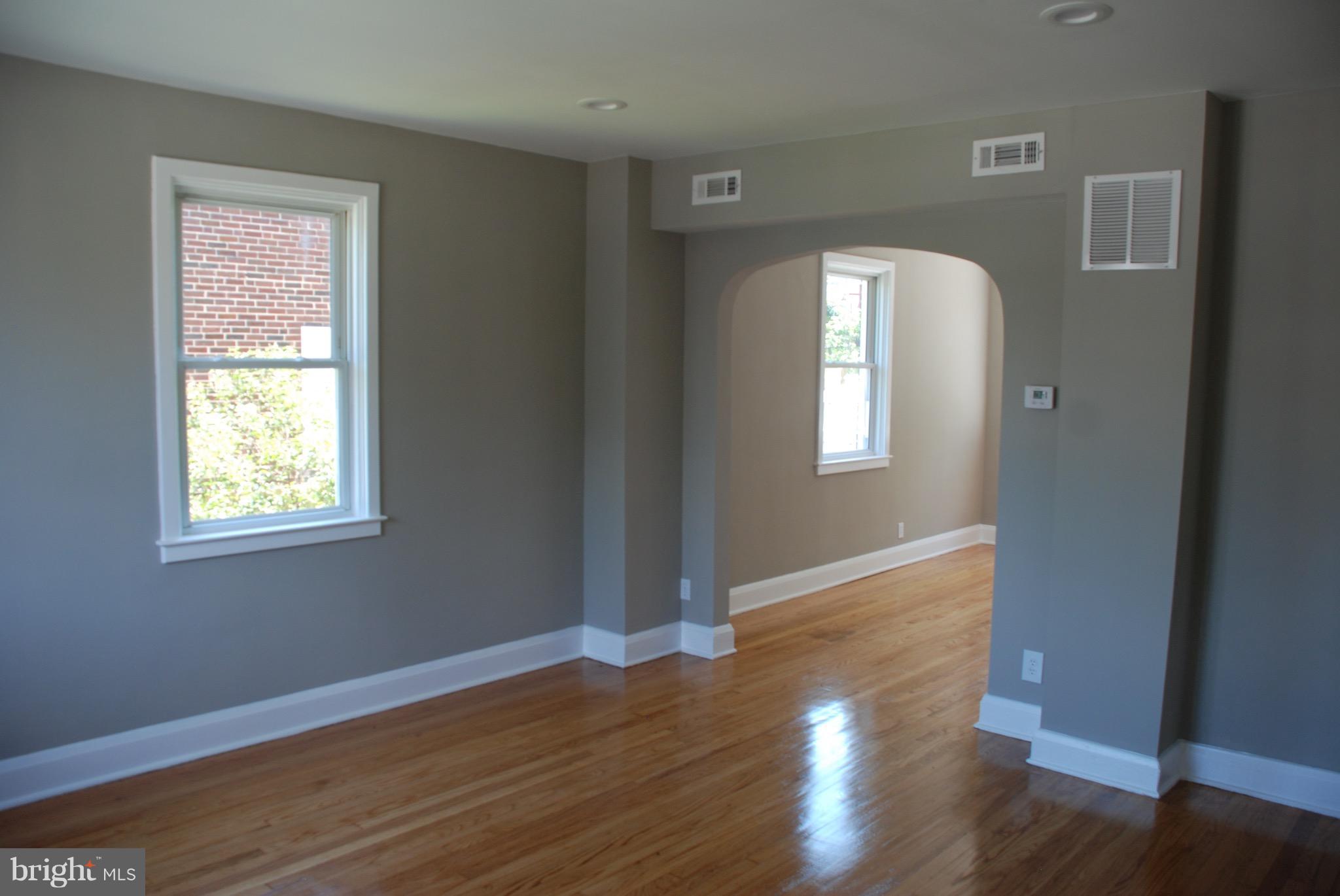 139 West Meadow Road Baltimore, MD 21225 - Photo 4 of 11 wooden floor in an empty room with a window