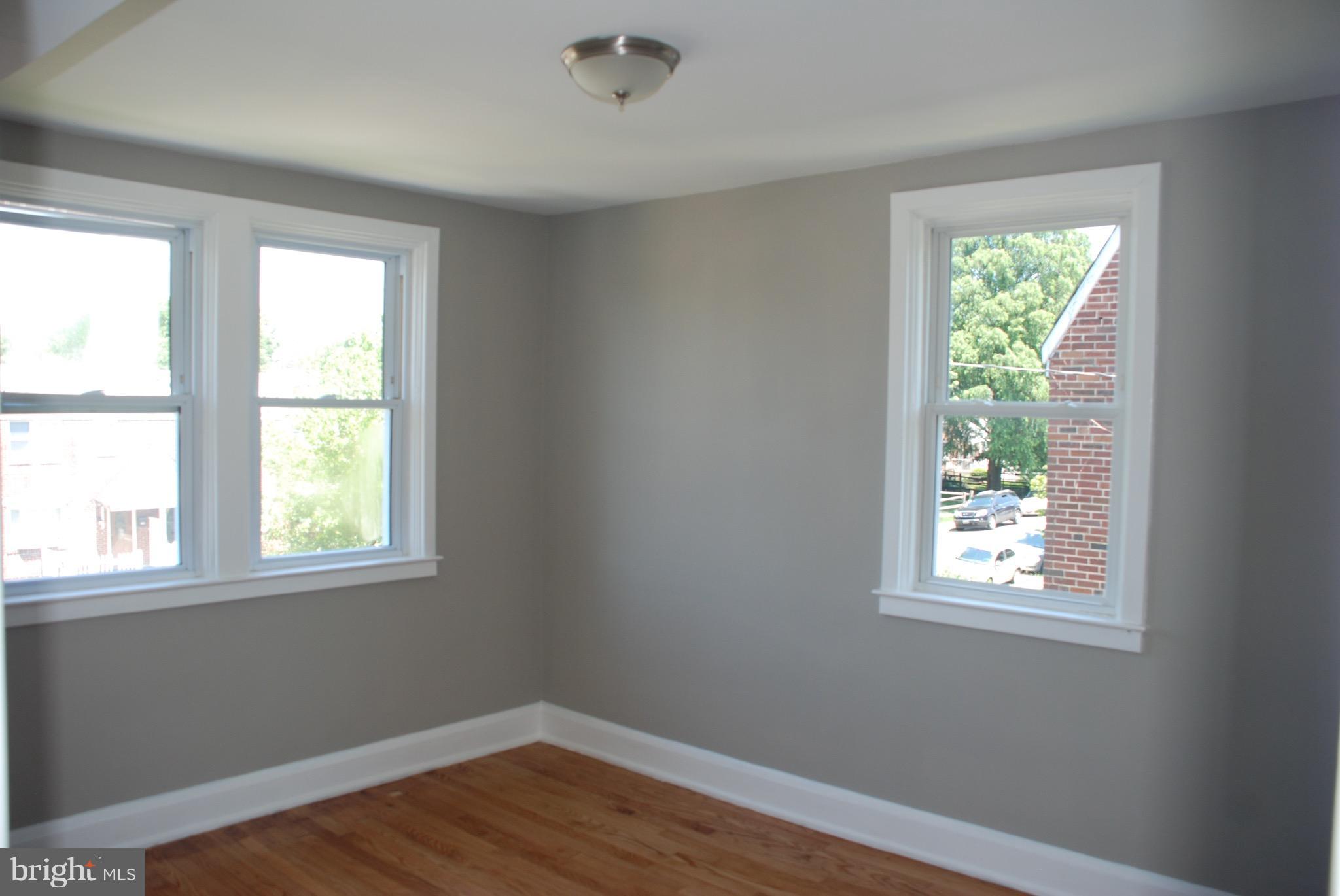 139 West Meadow Road Baltimore, MD 21225 - Photo 9 of 11 a view of an empty room with wooden floor and a window