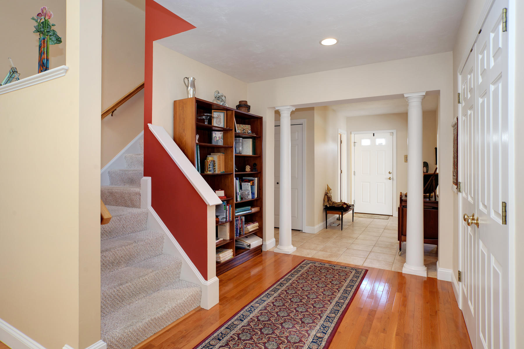 20 Stratford Ridge, Unit 124 Mashpee, MA 02649 - Photo 2 of 34 a view of a hallway with wooden floor and stairs