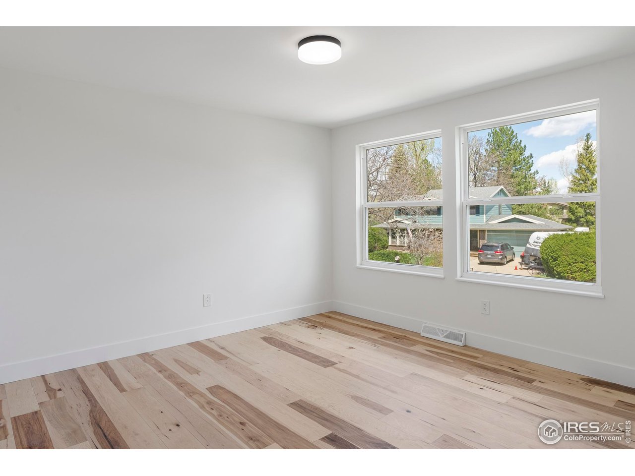 4223 Peach Way Boulder, CO 80301 - Photo 29 of 40 an empty room with wooden floor and windows
