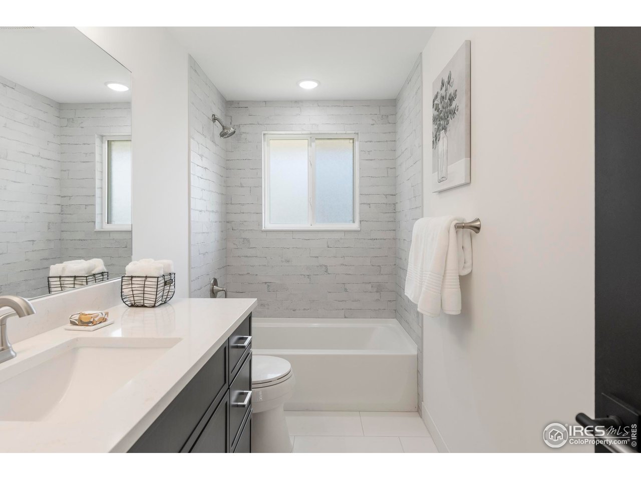 4223 Peach Way Boulder, CO 80301 - Photo 32 of 40 a bathroom with a sink a mirror and a bathtub